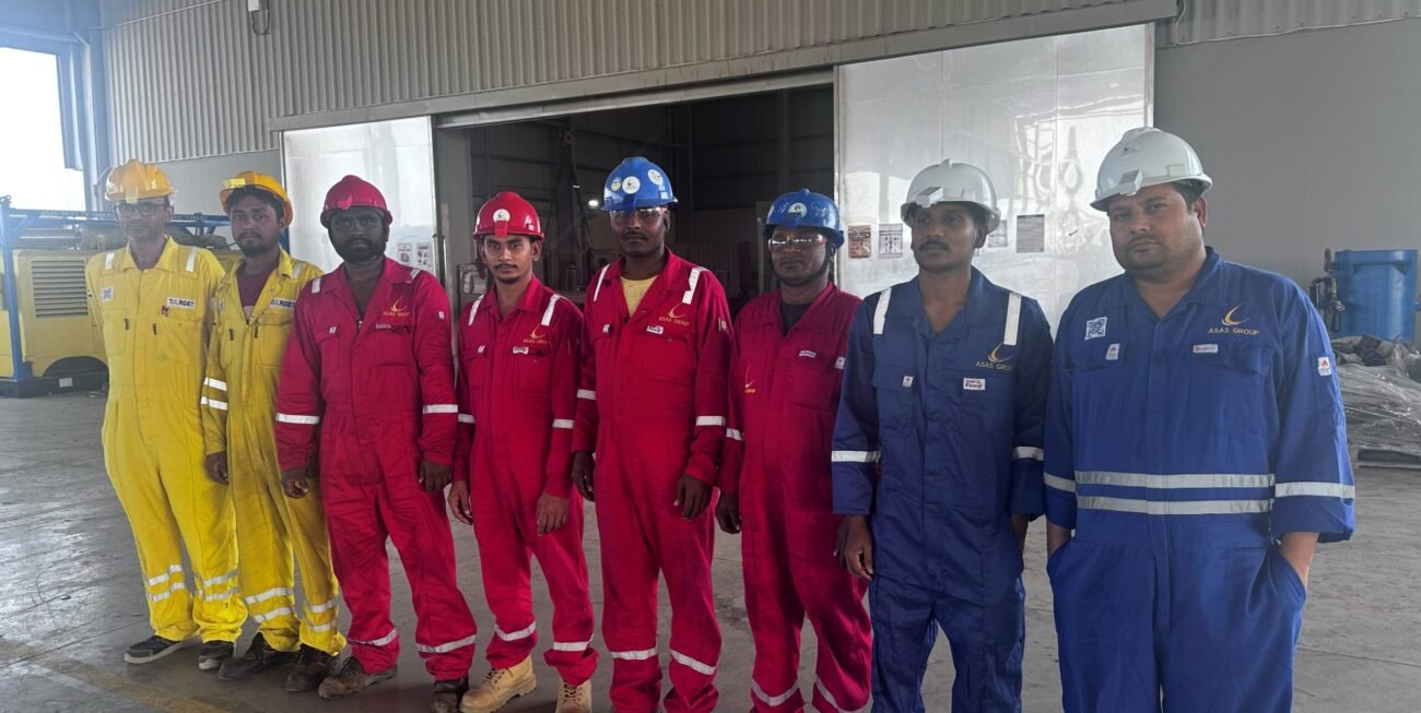 A group of men in overalls and helmets standing in a line AI-generated content may be incorrect.